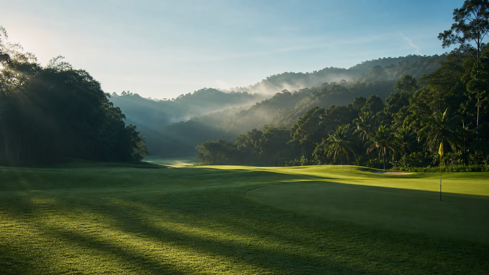 Tropical Malaysian golf course in rainforest at sunrise